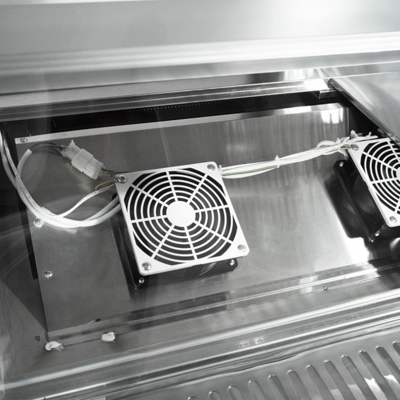 Two fans mounted on a metallic surface with a reflective background