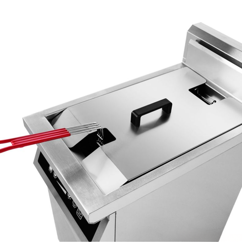 Stainless steel deep fryer with red handle on a white background