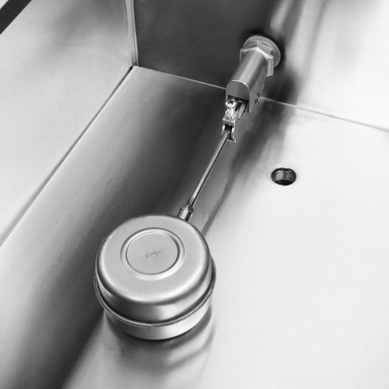 Metallic kitchen sink strainer with a visible brand logo on a stainless steel sink.
