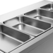 Stainless steel kitchen sink with divided compartments on a light gray background