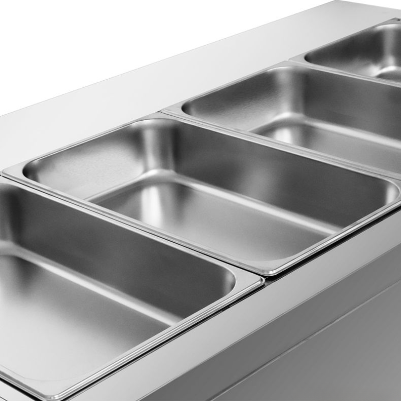 Stainless steel kitchen sink with divided compartments on a light gray background