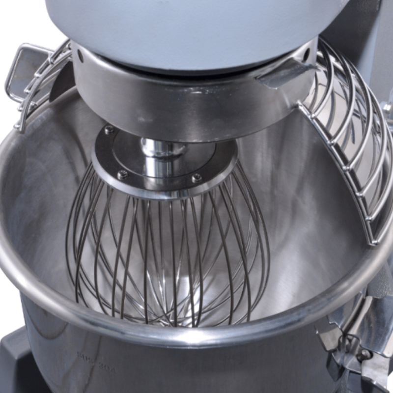 Close-up of a stand mixer with a whisk attachment inside a bowl.