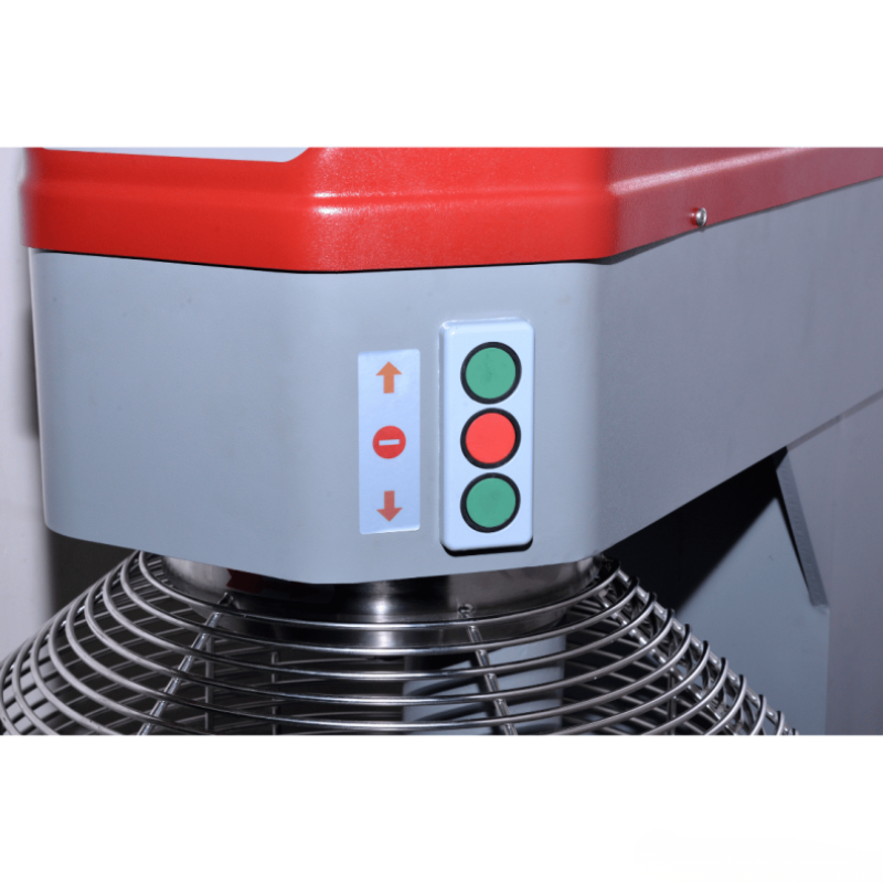 Control panel with red, green, and gray buttons on a machine.