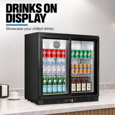 Thermaster LG-208SC black two-door bar fridge stocked with soft drinks, water and beer, under a bench in a bar, captioned drinks on display